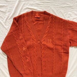 Official The Life of a Show Girl cardigan from Taylor Swift’s merch store.